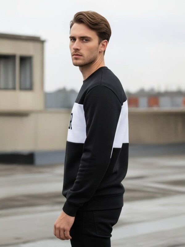 Stijlvol zwart-wit sweatshirt voor heren op dak.